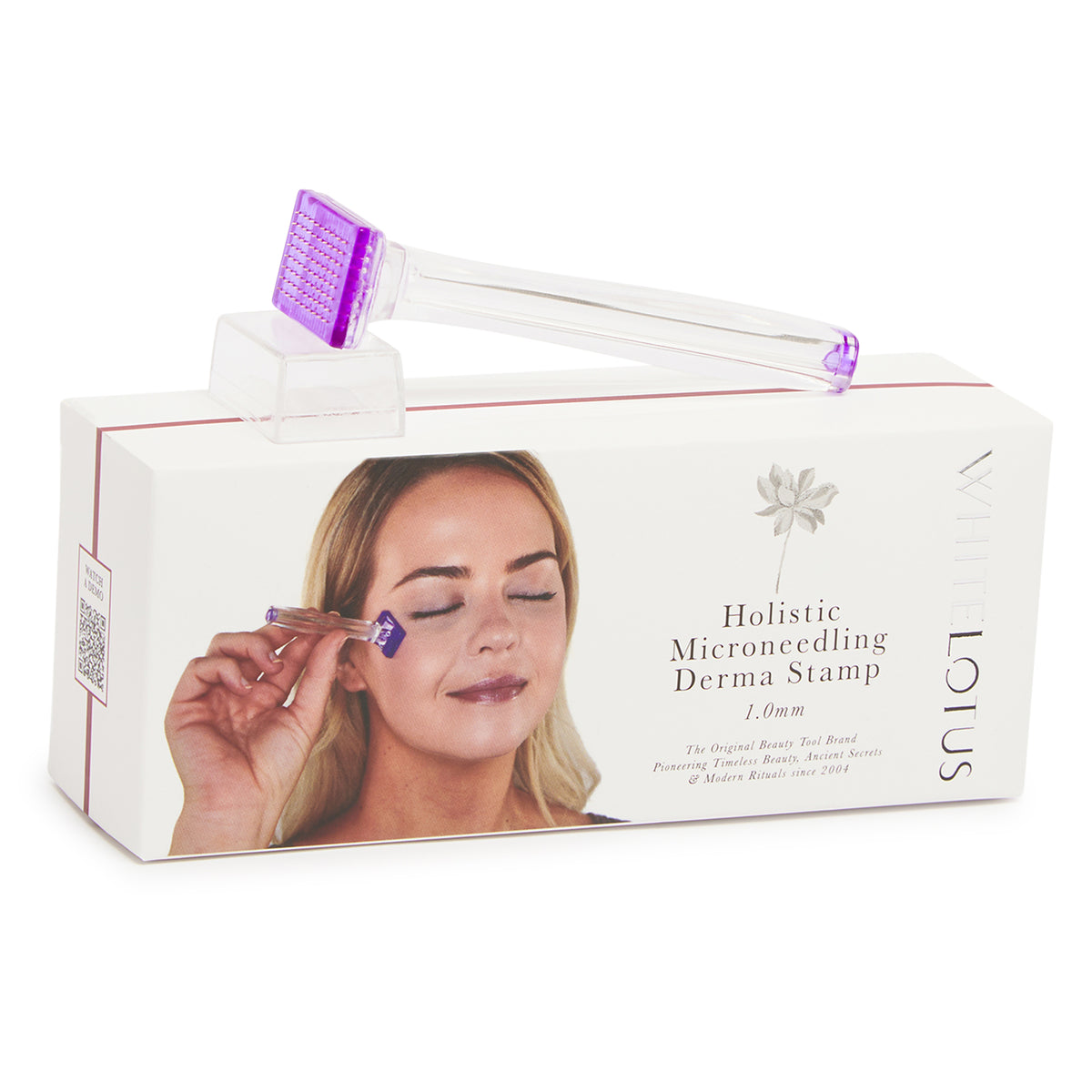White Lotus Holistic Microneedling Derma Stamp in matte orange with a purple-tinted needle head, shown resting on its white retail box against a white background.